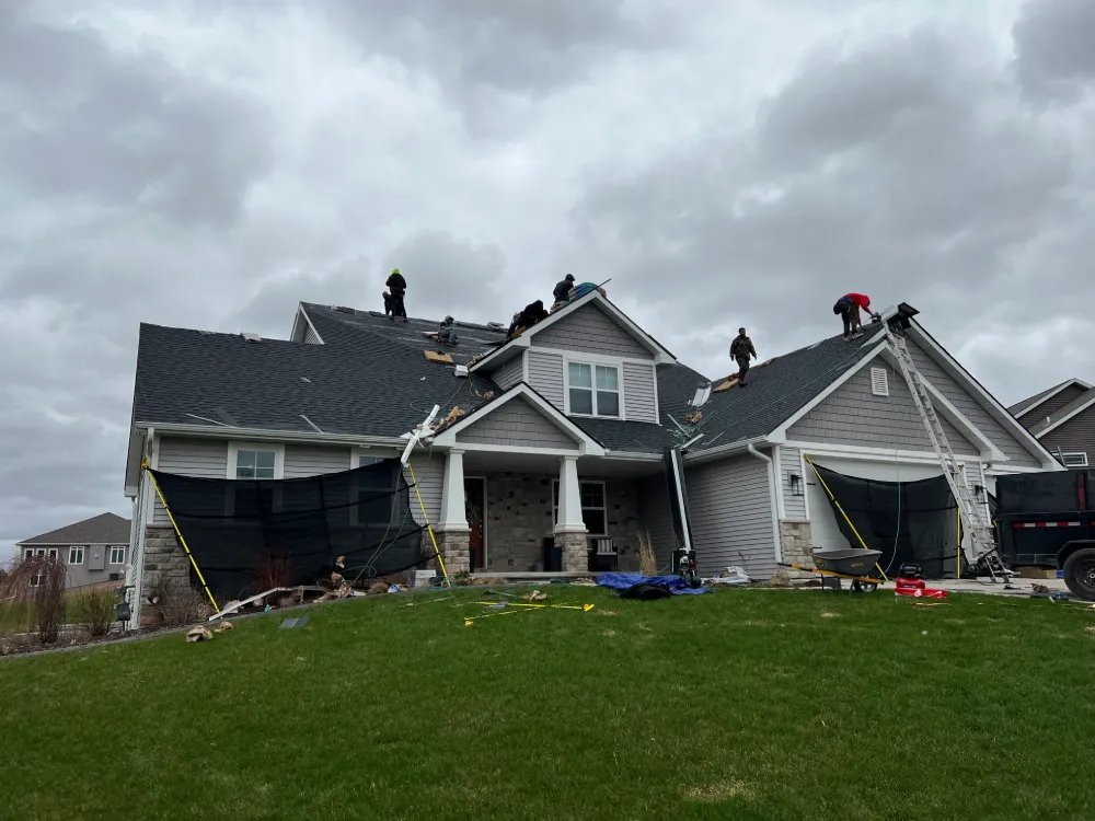 Full crew roof replacement team at work